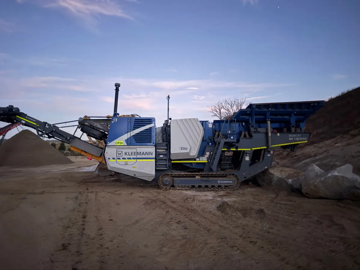 Kleemann Mobicat MC 110 EVO2 tracked jaw crusher beside a stockpile