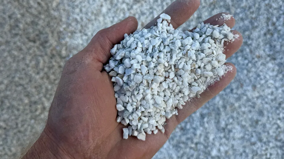 5mm Ultra White Chip: small bright white chips in a hand